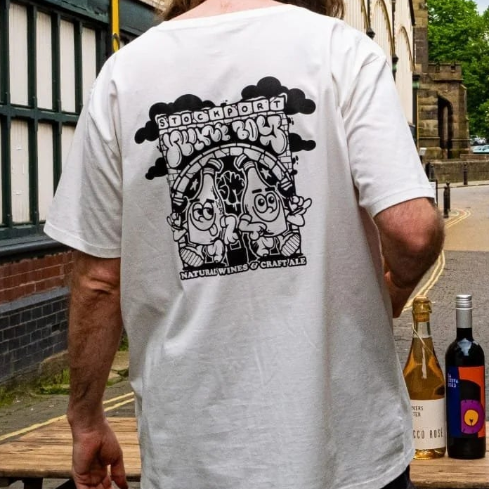 Person wearing a Wine Boy branded t-shirt, standing next to Stockport Indoor Market.